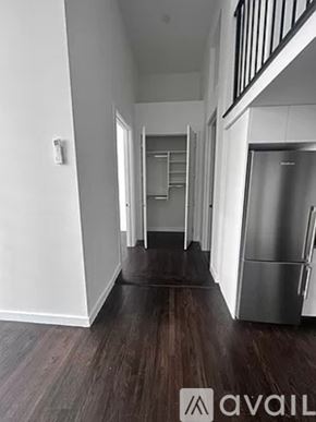 New York apartment for rent - A hallway with a refrigerator on the right side.