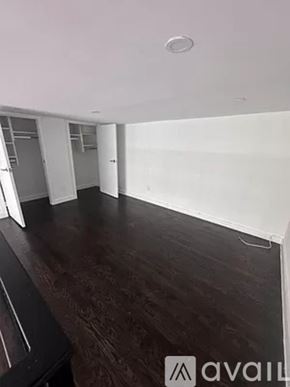 New York apartment for rent - A room with wooden flooring and white walls.