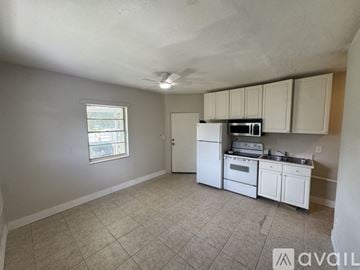 Orlando house for rent - A kitchen with white appliances and cabinets is available for rent.