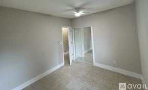 Orlando house for rent - A room with a carpeted floor and a ceiling fan.