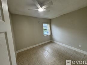 Orlando house for rent - A room with a ceiling fan and a window.
