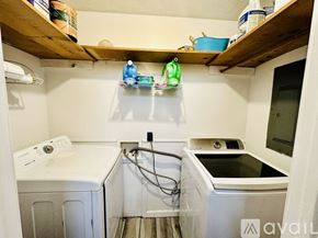 Henderson house for rent - A small laundry room with a washer and dryer.