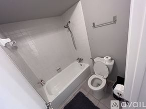 Plano house for rent - A white bathroom with a toilet, sink, and bathtub.