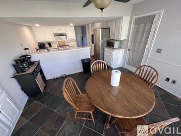 Plano house for rent - A kitchen with a table and chairs in the middle of the room.