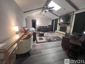 Plano house for rent - A living room with a fireplace and a television.