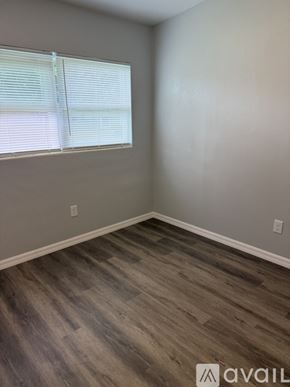 Sanford house for rent - A room with a window and wooden flooring.