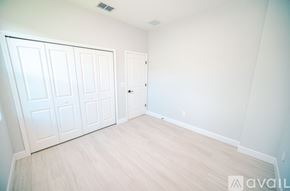 Kissimmee house for rent - A room with white doors and wooden flooring.
