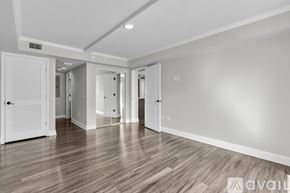 Kissimmee apartment for rent - A spacious room with wooden flooring and white walls.