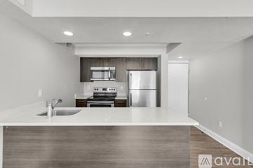 Kissimmee apartment for rent - A modern kitchen with a stainless steel refrigerator and a sink.