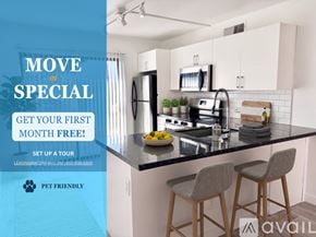 Phoenix apartment for rent - A kitchen with black countertops and white cabinets.
