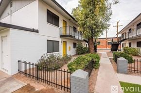 Phoenix apartment for rent - A kitchen with a stainless steel refrigerator, black countertops, and white cabinets.