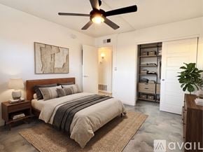 Phoenix apartment for rent - A bedroom with a large bed and a ceiling fan.