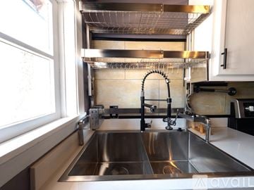 Phoenix house for rent - A modern kitchen with a stainless steel sink and faucet.