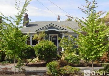 Seattle house for rent - A kitchen with wooden cabinets and a white stove.