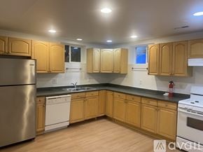 Seattle house for rent - A kitchen with wooden cabinets and a white dishwasher.