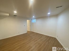 Seattle house for rent - A room with wooden flooring and white walls.