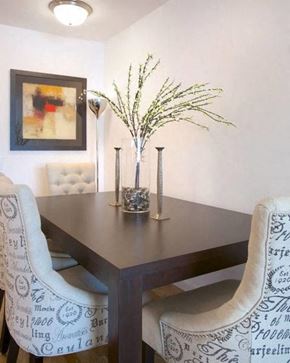 New York apartment for rent - a dining room table with two chairs and a vase of flowers
