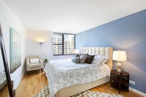 New York apartment for rent - a bedroom with a large bed and a large window