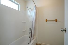 Colorado City house for rent - A white bathroom with a tub and a towel rack.