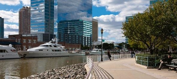 Jersey City apartment for rent - a boat is docked in the water near a city