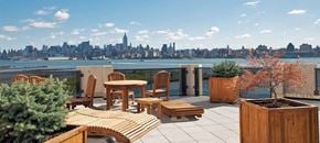 Jersey City apartment for rent - a balcony with a table and chairs and a view of the city