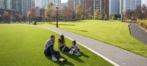 Jersey City apartment for rent - a family playing with a soccer ball in a park