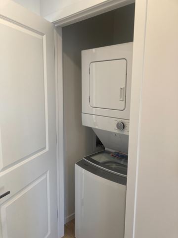 Canso apartment for rent - A white dishwasher is built into a kitchen cabinet.