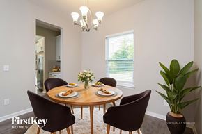 High Point house for rent - A dining room with a round table set for four.