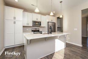 High Point house for rent - A kitchen with white cabinets and a white island.