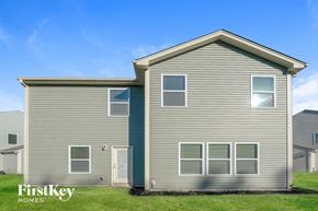 High Point house for rent - A grey house with the words "FirstKey Homes" on the grass in front.