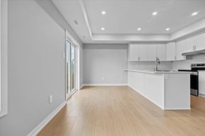 Arnprior apartment for rent - A kitchen with white cabinets and a wooden floor.