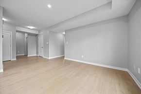 Arnprior apartment for rent - A spacious room with wooden flooring and white walls.