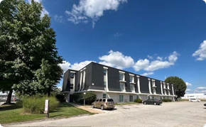Springfield apartment for rent - A modern building with a parking lot in front.