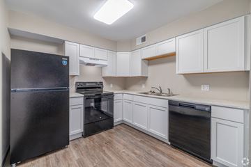 Springfield apartment for rent - A kitchen with black appliances and white cabinets.