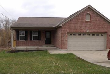 Burlington house for rent - A red brick house with a white garage door.