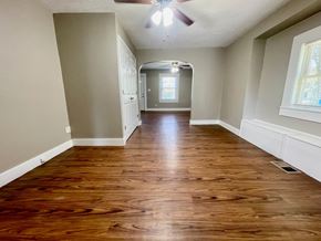 New Albany house for rent - A long hallway with wood floors and a ceiling fan.