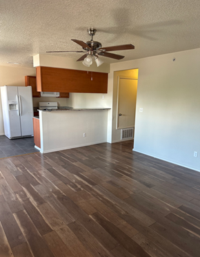 Albuquerque apartment for rent - A room with a ceiling fan and wooden flooring.