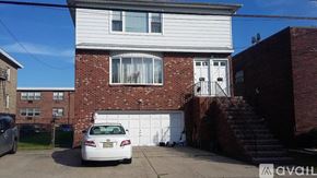 Belleville apartment for rent - A white car is parked in front of a brick house.