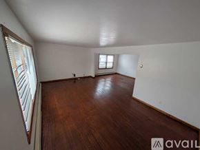Belleville apartment for rent - A room with wooden floors and two windows.