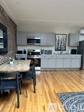 Ellsworth apartment for rent - A kitchen with a table and chairs in front of a brick wall.