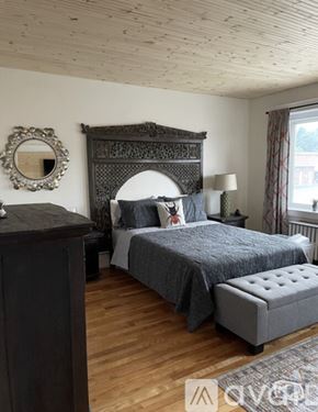 Ellsworth apartment for rent - A bedroom with a large bed and a wooden dresser.