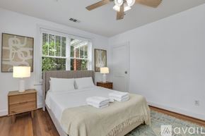 Savannah house for rent - A bedroom with a large bed and a window with blinds.