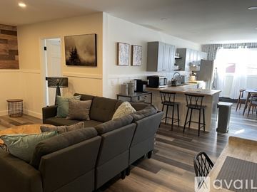 Ellsworth apartment for rent - A living room with a grey couch and a wooden floor.