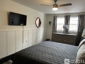 Ellsworth apartment for rent - A bedroom with a bed, dresser, and television.