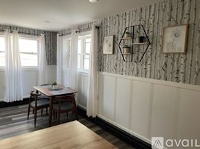 Ellsworth apartment for rent - A dining room with a table set for two and a wallpapered wall.