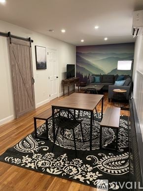 Ellsworth apartment for rent - A living room with a black and white rug and a wooden table.