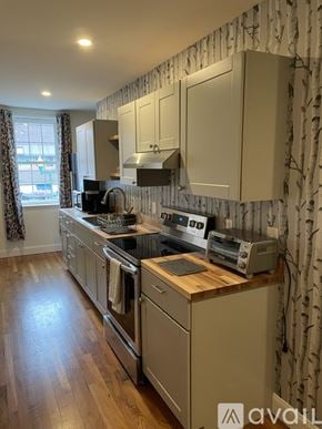 Ellsworth apartment for rent - A kitchen with wooden floors and a patterned wallpaper.