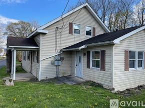 Claysburg apartment for rent - A house with a beige siding and a white door is for sale.
