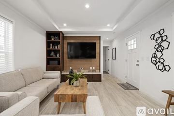 Harford house for rent - A living room with a wooden coffee table and a grey sofa.
