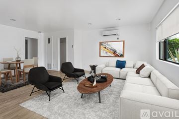 Los Angeles apartment for rent - A living room with a white couch, a coffee table, and a painting on the wall.
